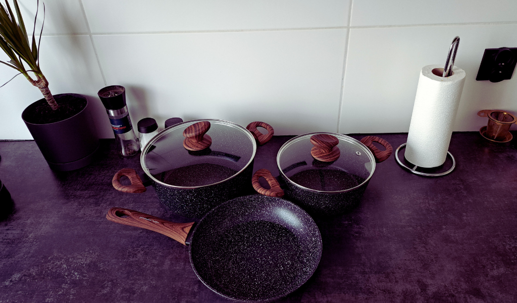 kitchenware including pots and pans on a work surface